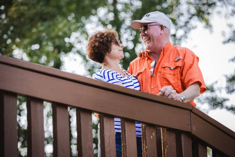 The Murphys smiling while walking on a bridge